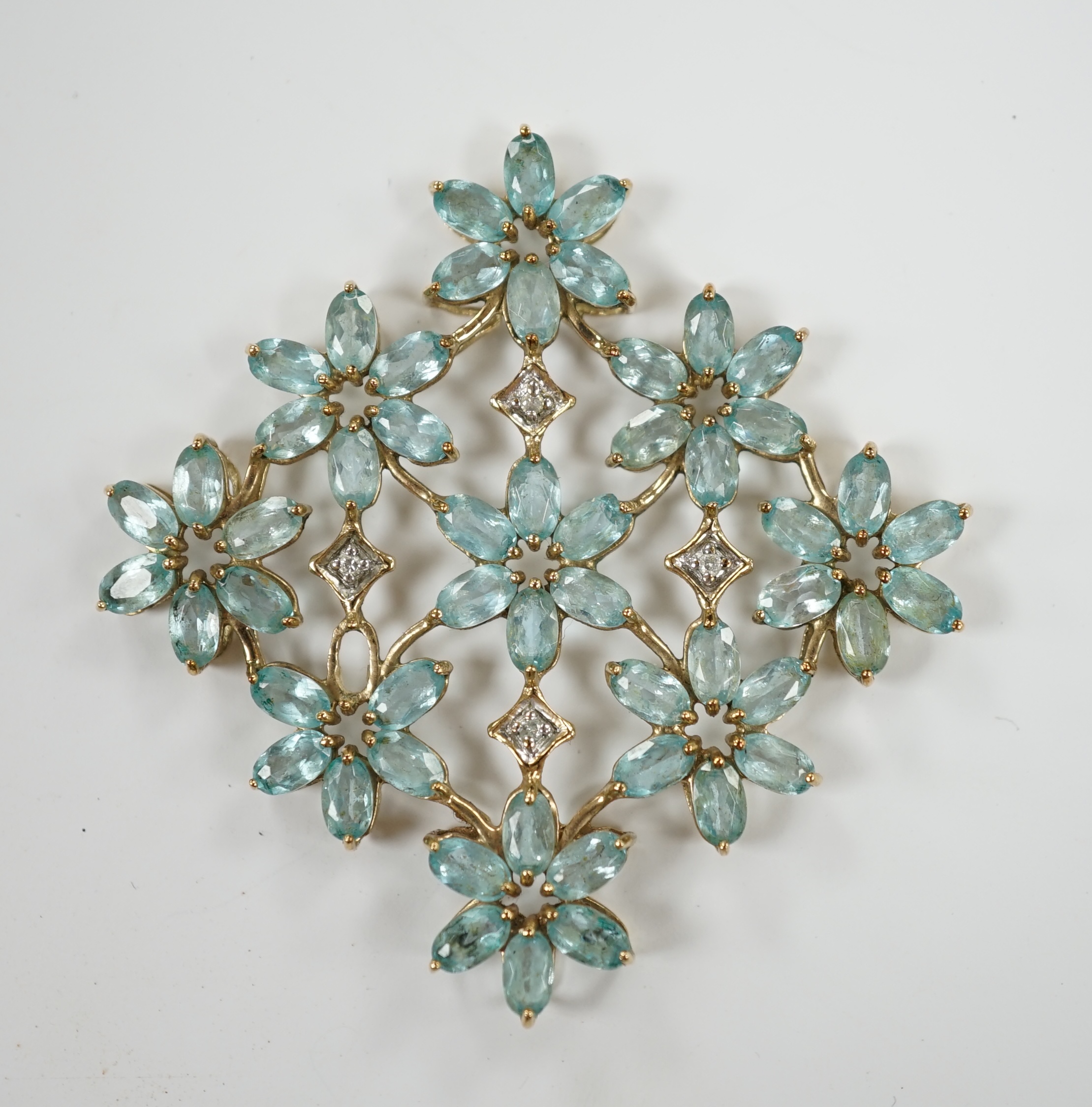 A yellow metal and blue topaz and diamond chip cluster set multi flower head pendant, 51mm, gross weight 9.1 grams.